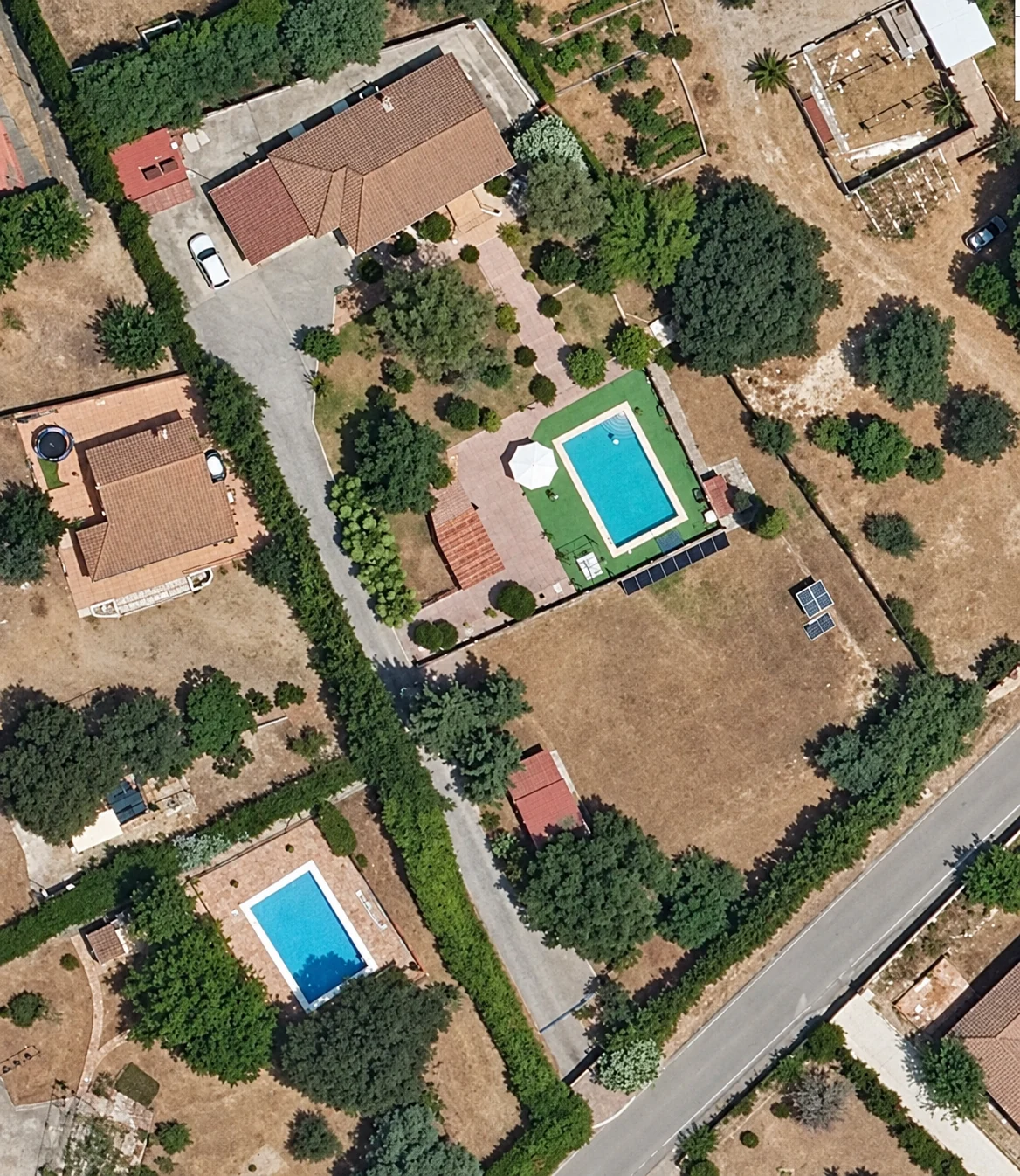 Enhanced aerial image showing the villa, pool, garden and outbuildings